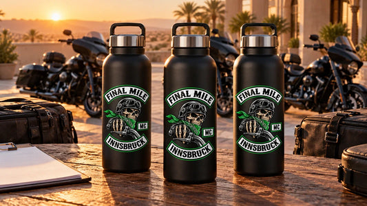 Final Mile Innsbruck club water bottles on a finish-day handover table beside luggage and parked V-twin motorcycles near Cairo