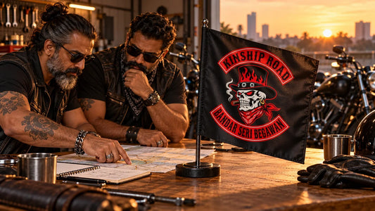 Two motorcycle club coordinators planning beside a custom Kinship Road Bandar Seri Begawan flag with the logo printed naturally into the fabric.