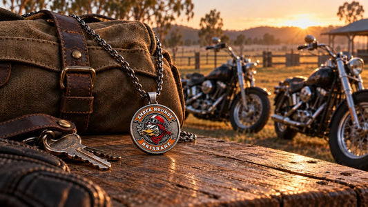 Ember Hounds Brisbane club pendant beside an overnight bag and parked historic V-twin motorcycles before a Kyogle rally weekend.
