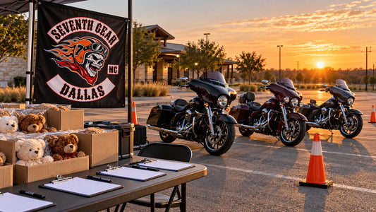 Motorcycle charity ride staging area with parked V-twin cruisers, teddy bear donation boxes and coordinated club event gear.