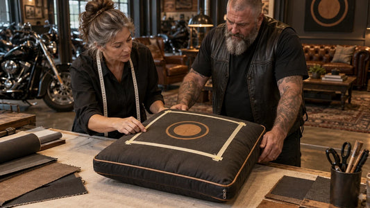 A motorcycle club organizer and textile specialist inspect emblem placement on a curved filled cushion.