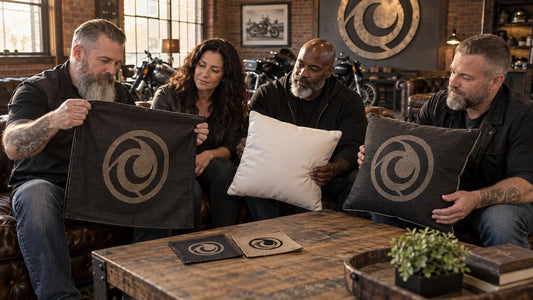 Mature motorcycle club organizers compare cover-only and filled custom cushion samples in a clubhouse lounge.