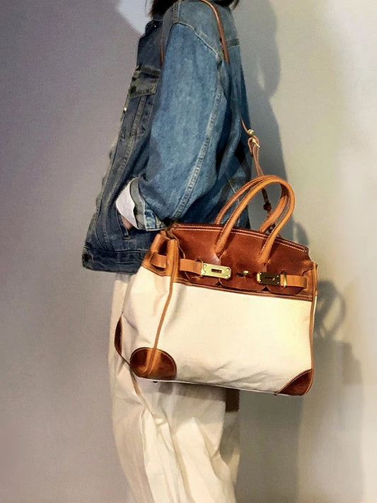 hand-stitched vegetable-tanned leather top-handle bag 1