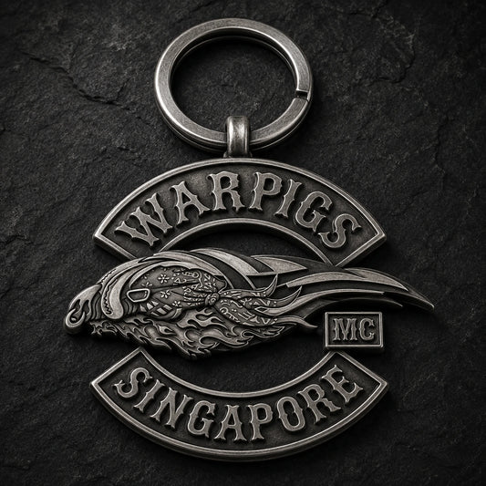 Antique silver motorcycle club logo keychain with raised monochrome relief and a heavy split ring.