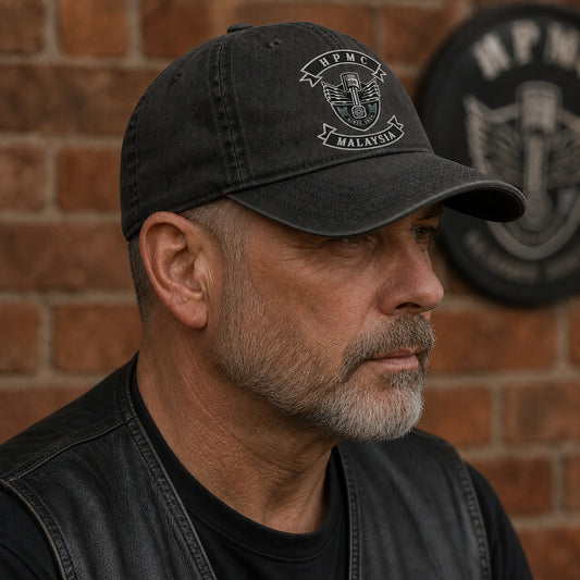 Side view of a rider wearing a low-profile motorcycle club cap with an authorized club emblem.