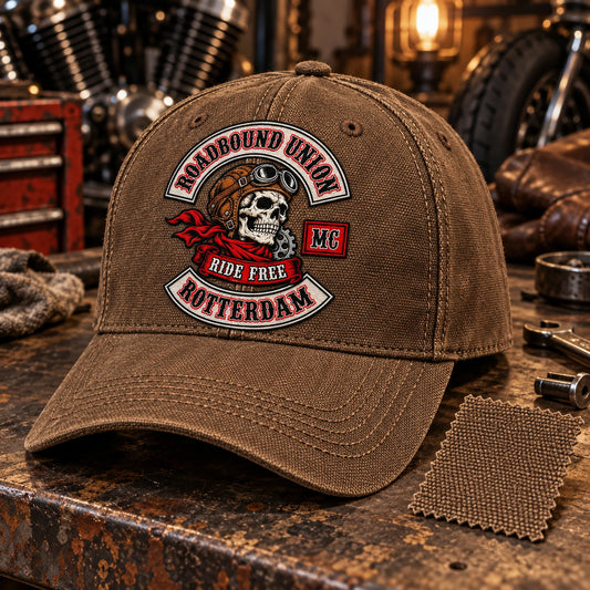 Roadbound Union motorcycle club logo embroidered on a rugged brown canvas cap with coarse heritage texture.