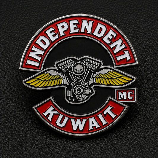 Front view of an Independent Kuwait motorcycle club enamel pin on black leather.
