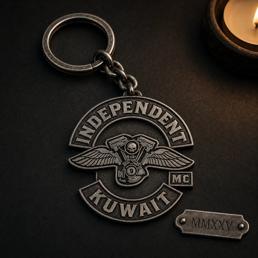 Antique metal motorcycle club anniversary keychain with a monochrome authorized emblem and engraved memorial date.