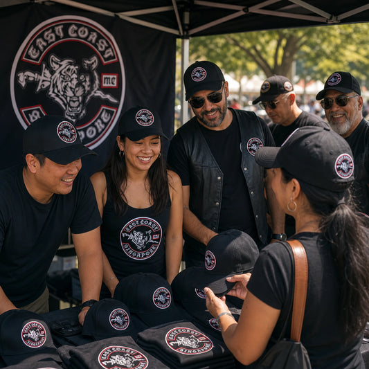 Supporters wearing custom caps with authorized motorcycle club logo elements at an outdoor event.