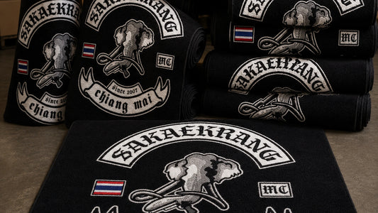 Multiple custom motorcycle club rugs are prepared for a bulk chapter order.