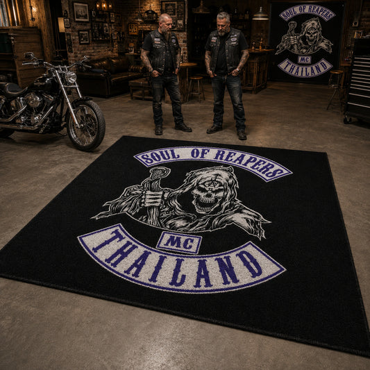 Two motorcycle club members stand beside a large finished clubhouse area rug and a full-size V-twin motorcycle.