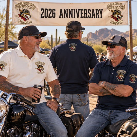Asphalt Coyotes Tucson members welcome riders at a 2026 anniversary rally in customized cream and navy polos.