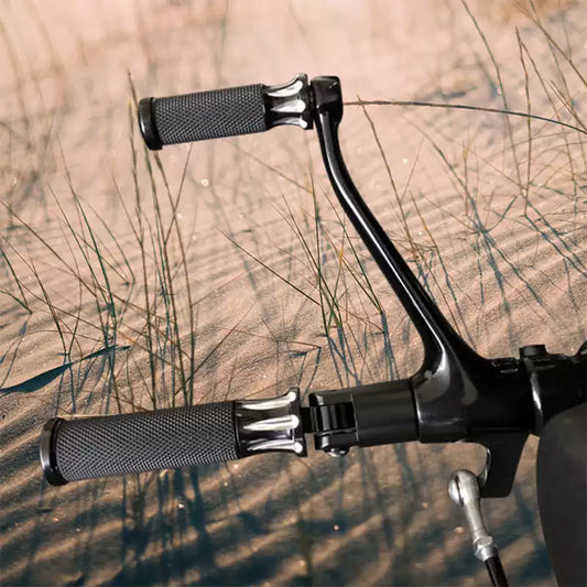 Pair of black Arlen Ness Fusion foot pegs installed on a Harley motorcycle