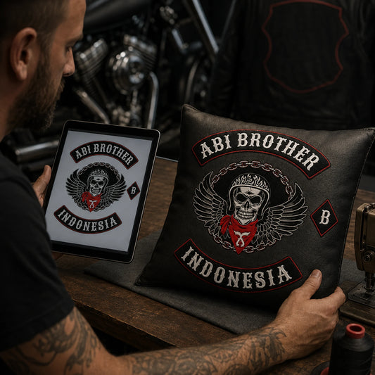 Designer compares approved motorcycle club artwork with a finished custom cushion.