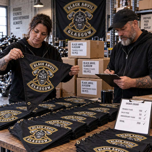 Fulfillment staff pack a bulk motorcycle club order of matching custom triangle flags.