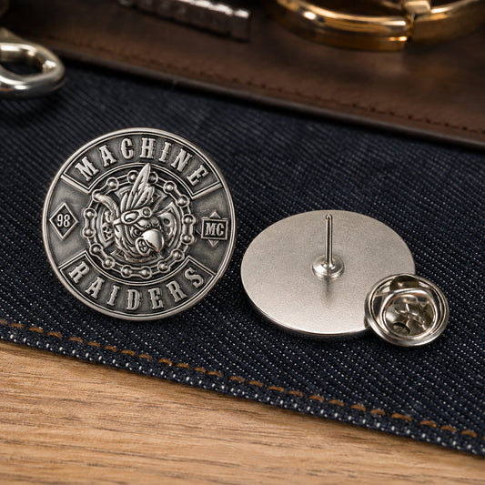 Compact connected silver MACHINE RAIDERS 3D club pin shown front and rear with a butterfly clutch.