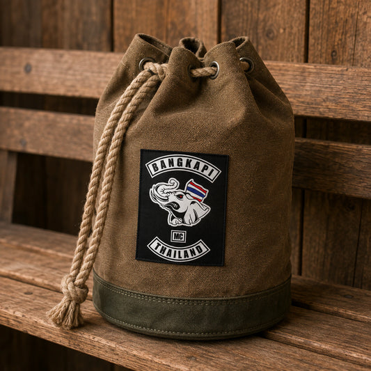 Waxed-brown heavy canvas motorcycle club drawstring bag with an oval reinforced base and natural rope.