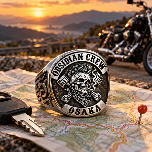 Stainless steel motorcycle club rally ring displayed on a route map at a mountain stop.