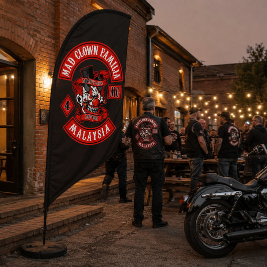 Clubhouse Displays: custom motorcycle club feather flag shown in warm brick clubhouse courtyard during an evening member gathering.