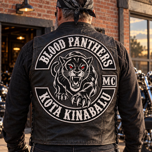 Complete fictional three-piece back Colors system with central emblem and coordinated upper and lower rockers for a motorcycle club, shown at brick clubhouse exterior.