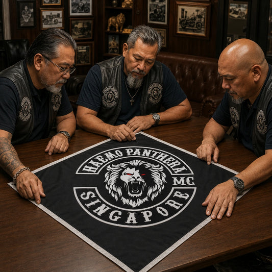 Three motorcycle club chapter officers review a full-color custom diamond flag proof before approving production.