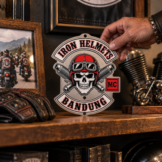 Compact motorcycle club metal sign displayed with rider memorabilia on a clubhouse shelf.