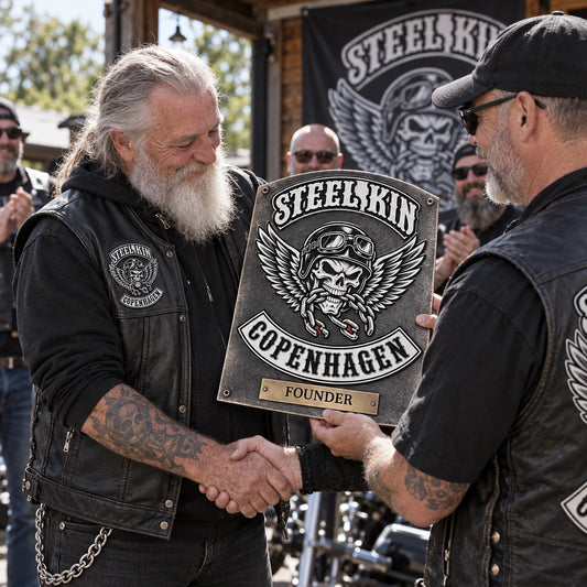 Motorcycle club founder receiving a custom metal recognition sign from chapter members.