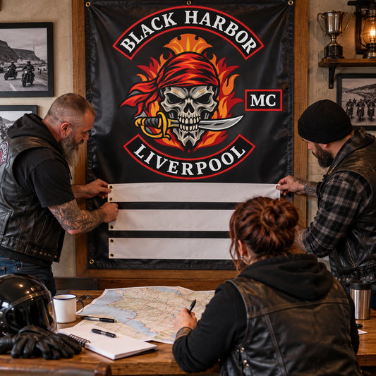 Motorcycle club members gathered around a personalized brotherhood event banner at dusk.