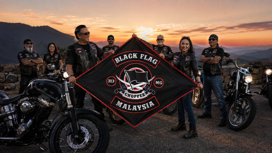 A motorcycle club chapter holds its custom diamond flag at a mountain turnout after a sunset ride with American V-twin motorcycles.