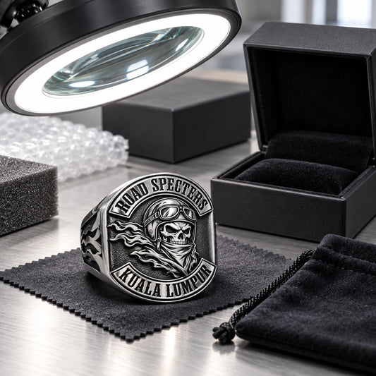 Finished stainless steel motorcycle club ring displayed at a final inspection and packing station.