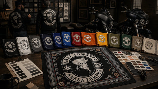Custom motorcycle club bandana featuring the authorized Lost Cowboys MC identity in club color approval table with fabric swatches, ink cards and one finished bandana under neutral proofing light.