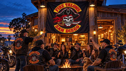 Motorcycle club members celebrate beneath an illuminated custom hanging flag that represents their shared identity.