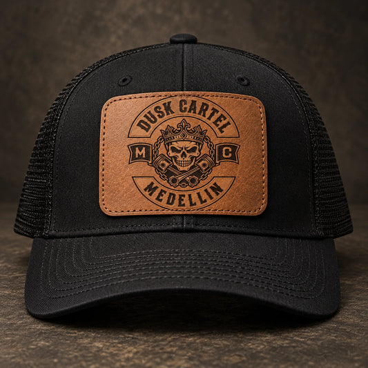 Rectangular motorcycle club leather patch on a black trucker hat.