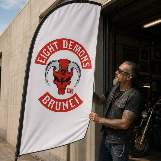 Custom Club Logo: custom motorcycle club feather flag shown in club officer inspecting a finished flag beside a garage doorway.