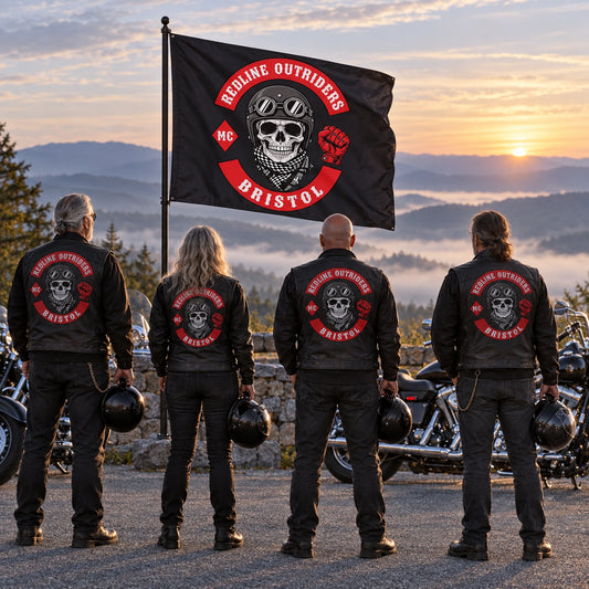 Four motorcycle club riders stand respectfully beside a custom memorial flag at a quiet dawn overlook.