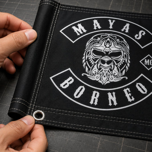 Close view of reinforced stitching, a metal eyelet and a pole sleeve on a custom motorcycle club flag.
