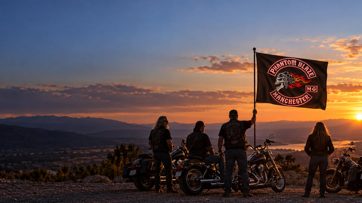Mature motorcycle club riders display a complete custom rally flag beside American V-twin cruisers at sunset.