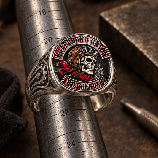 Realistically proportioned custom motorcycle club signet ring displayed on a jeweler's measuring mandrel.