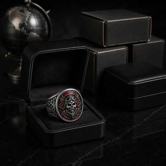 Custom antique silver motorcycle club ring presented in an open black leather box with unbranded shipping cartons and a metal globe behind it.