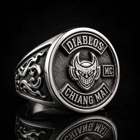 Sterling silver motorcycle club signet ring showing a devil emblem, polished edges and detailed side panel engraving.