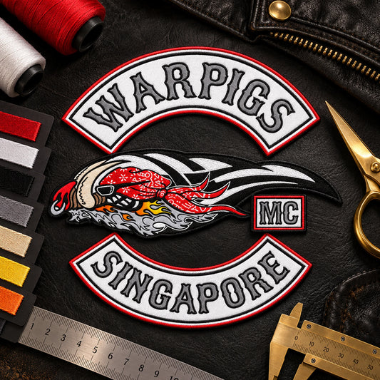 Solid sample patch with border and thread cards shown for a custom motorcycle club patch system in inspection desk.