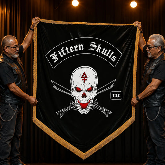 Two motorcycle club officers unveil a shield-shaped custom anniversary flag on a banquet stage.