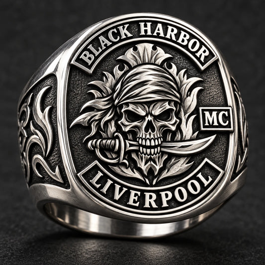 Stainless steel club ring with dark recessed detail and bright raised emblem surfaces.