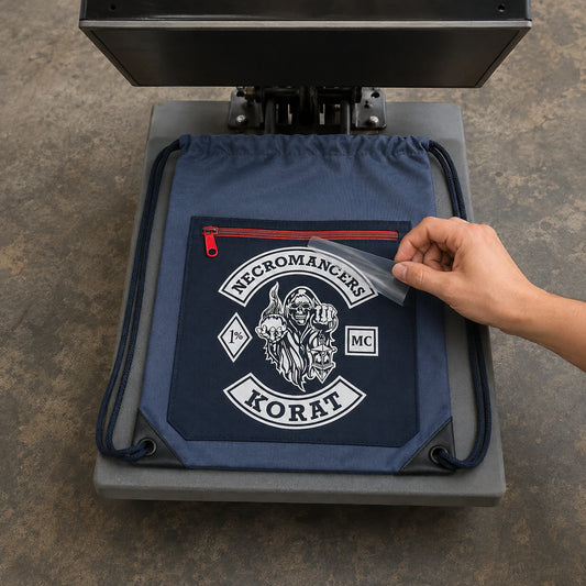 Detailed multi-color motorcycle club artwork is applied to a drawstring bag by heat transfer.