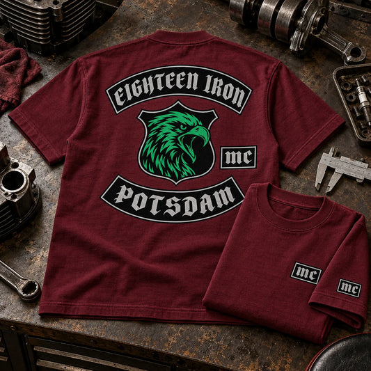 Eighteen Iron Potsdam burgundy 255 GSM heavyweight club T-shirt with reinforced construction and a compact MC sleeve badge on a workshop table.