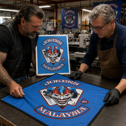 A rider and artisan compare the authorized club logo with its clean reproduction on custom diamond flag fabric.