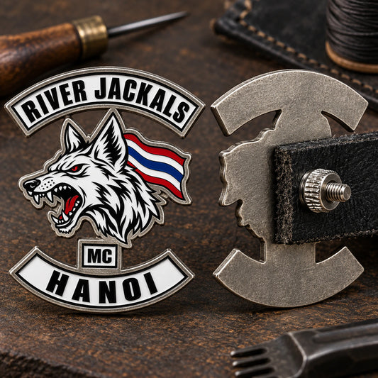 River Jackals motorcycle club badge secured through thick leather with a threaded screw post and knurled nut.