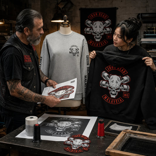 A designer and rider review print and embroidery samples for a custom motorcycle club hoodie layout.
