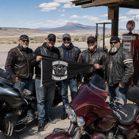 A group of mature heavyweight V-twin owners display their custom club triangle flag during an open-road fuel stop.