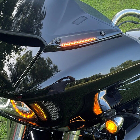 Amber LED windshield trim light installed on a black Harley Road Glide fairing
